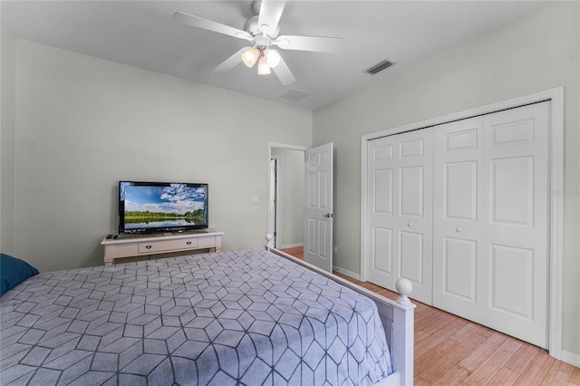 bedroom featuring ceiling fan, light hardwood / wood-style floors, and a closet