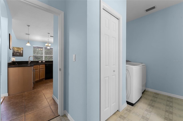 washroom featuring sink and washer / dryer