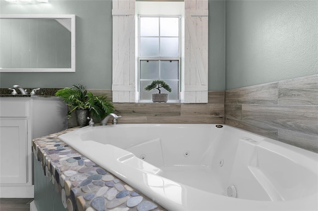 bathroom with a washtub and sink