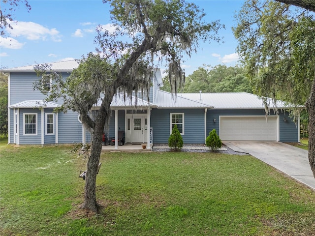 view of front of property featuring a garage and a front lawn