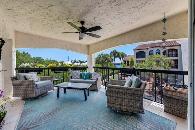 view of patio / terrace with an outdoor living space, ceiling fan, and a balcony