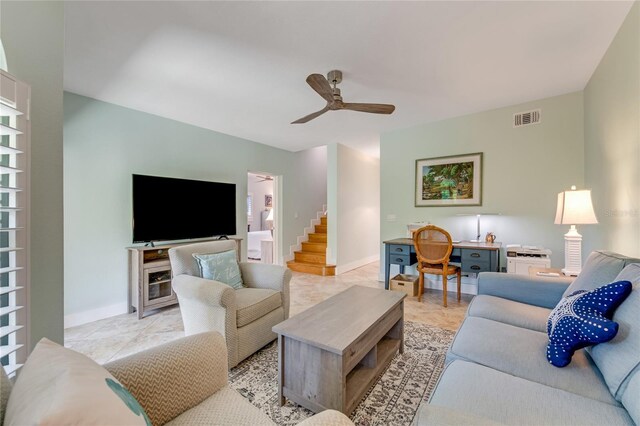 living room with light tile patterned floors and ceiling fan