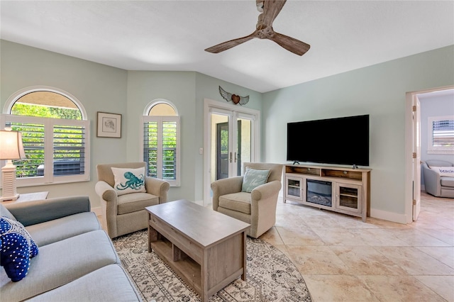 living room featuring a healthy amount of sunlight, ceiling fan, and french doors