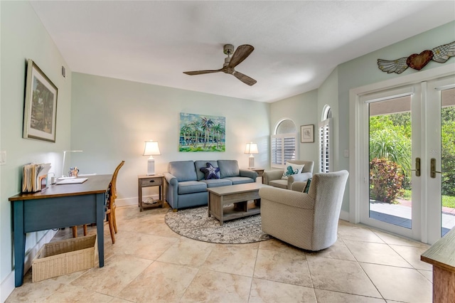 tiled living room featuring ceiling fan and french doors