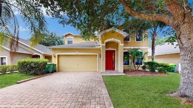 mediterranean / spanish-style home featuring a garage and a front yard