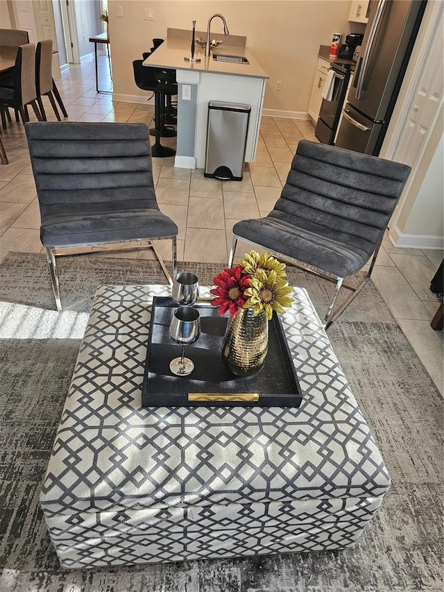 interior space featuring tile floors, sink, stainless steel fridge, and stove