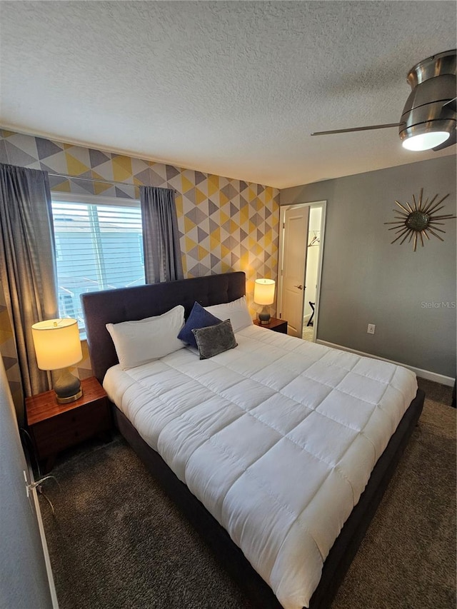 carpeted bedroom featuring a textured ceiling and ceiling fan