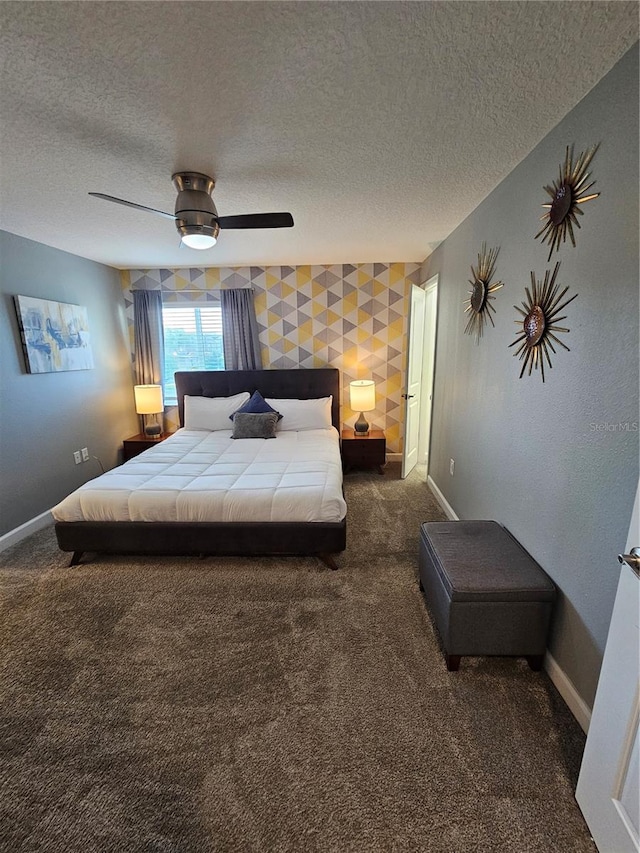 carpeted bedroom featuring a textured ceiling and ceiling fan