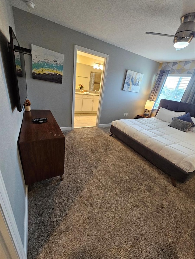 carpeted bedroom featuring ceiling fan, a textured ceiling, and connected bathroom