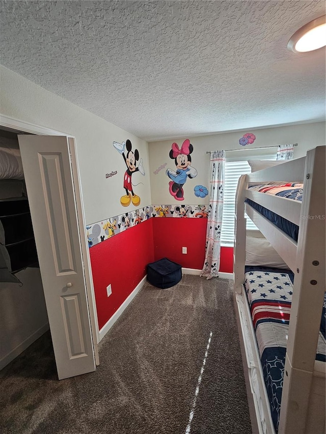 carpeted bedroom with a textured ceiling