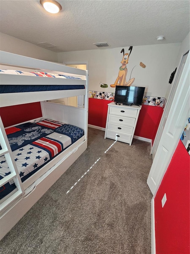 carpeted bedroom featuring a textured ceiling