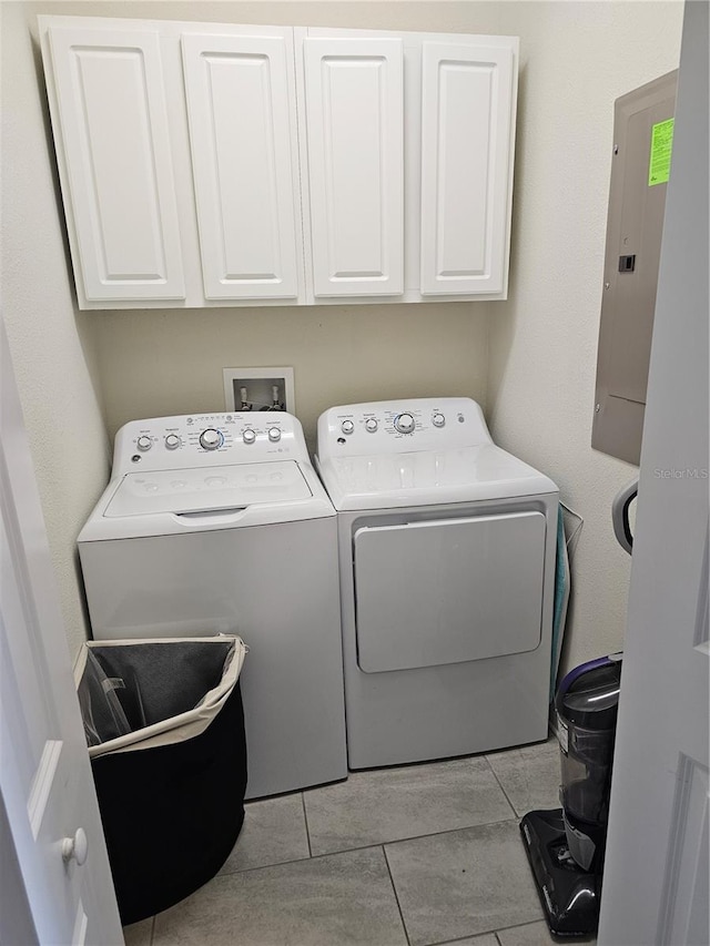 clothes washing area featuring separate washer and dryer, washer hookup, light tile flooring, and cabinets