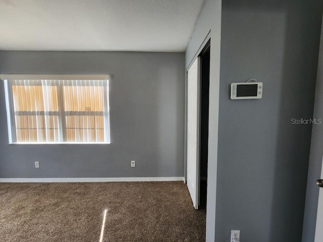 unfurnished bedroom with a closet, a textured ceiling, and carpet flooring