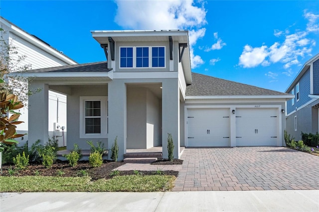 view of front of home with covered porch and a garage