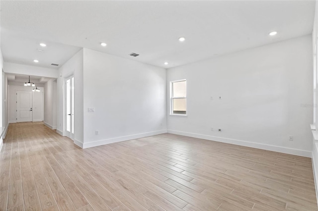 spare room featuring light hardwood / wood-style flooring