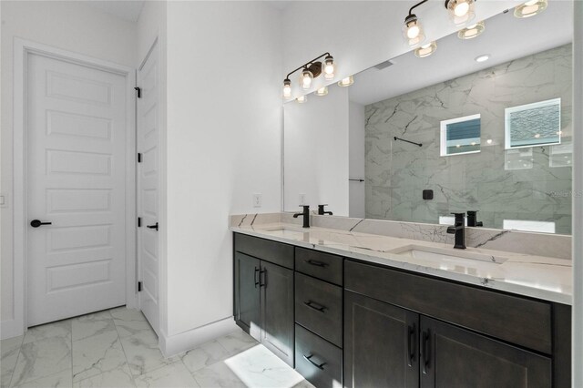 bathroom featuring a tile shower and vanity