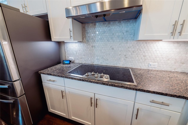 kitchen with backsplash, stainless steel refrigerator, electric cooktop, and ventilation hood