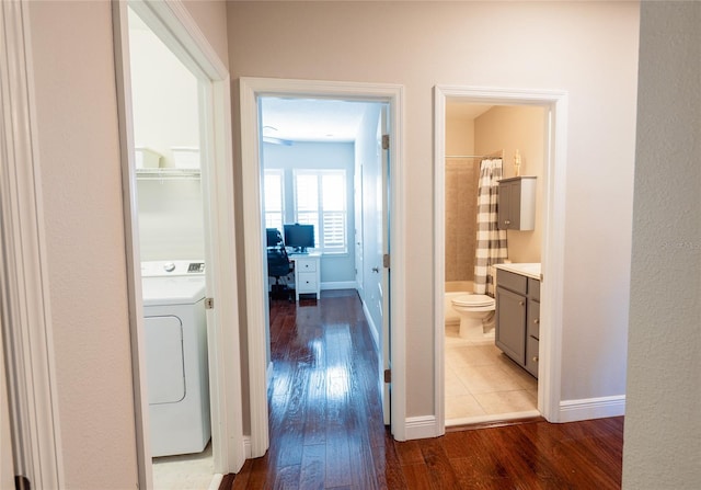 corridor featuring washer / clothes dryer and light hardwood / wood-style floors