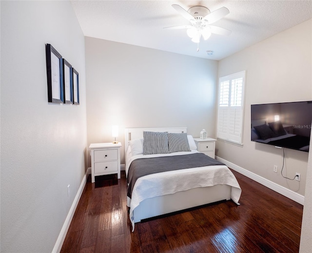 bedroom featuring ceiling fan and dark hardwood / wood-style flooring