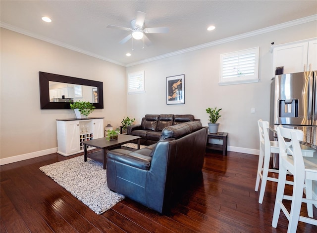 living room featuring dark hardwood / wood-style floors, ceiling fan, ornamental molding, and a wealth of natural light