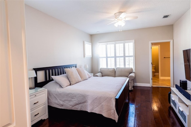 bedroom featuring a textured ceiling, dark hardwood / wood-style floors, ceiling fan, and ensuite bathroom