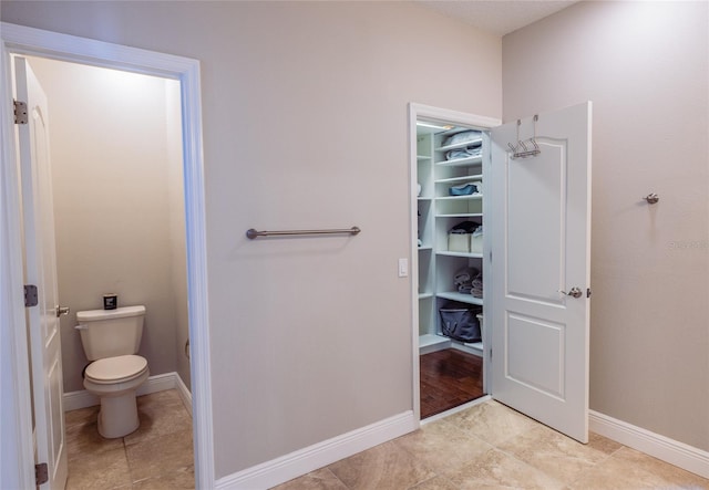 bathroom featuring tile patterned flooring and toilet