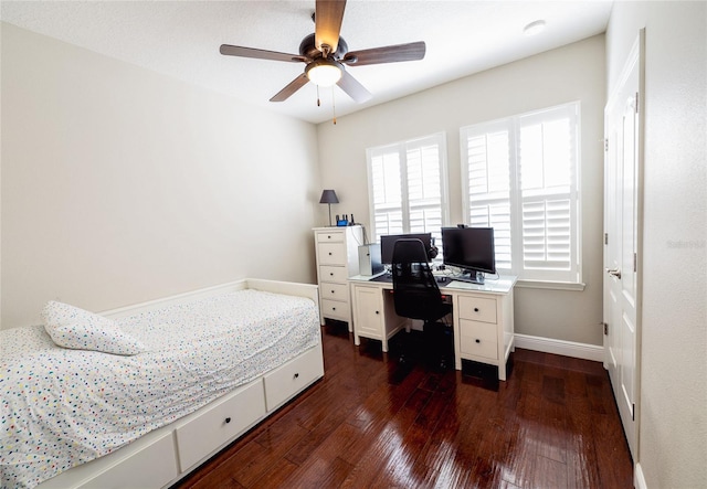 bedroom with dark hardwood / wood-style flooring and ceiling fan