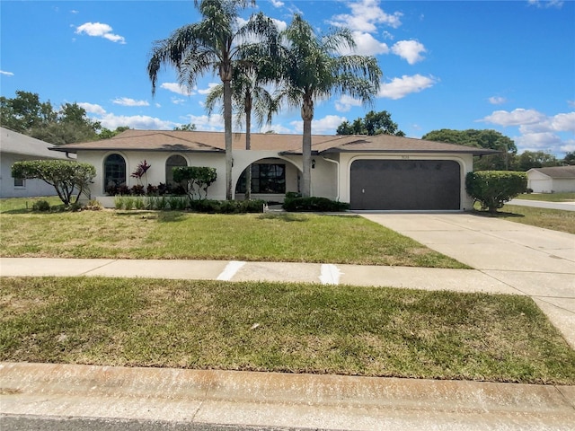 view of front of house with a front yard and a garage