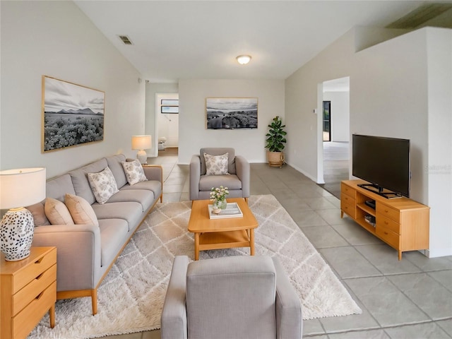 tiled living room featuring vaulted ceiling