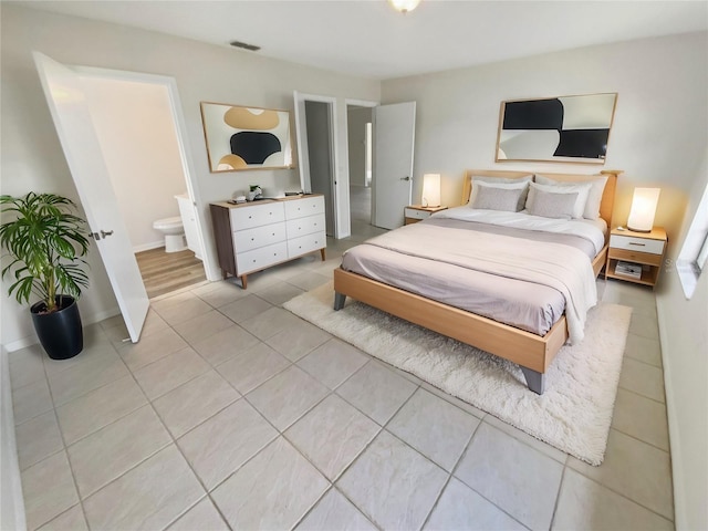 tiled bedroom with connected bathroom