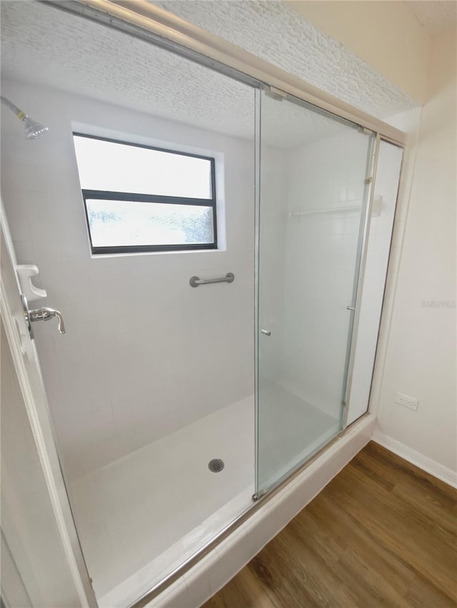 bathroom featuring walk in shower and hardwood / wood-style flooring