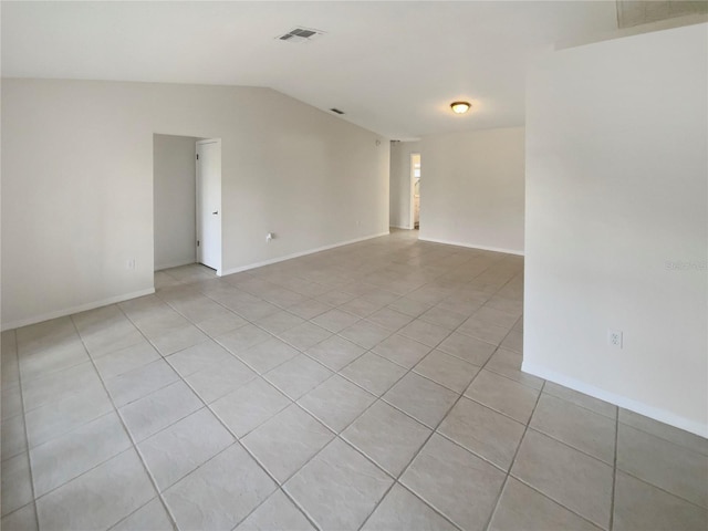 tiled empty room with lofted ceiling