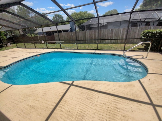 view of swimming pool featuring a lawn, a lanai, and a patio