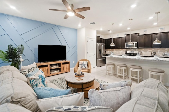 living room featuring light tile patterned flooring and ceiling fan