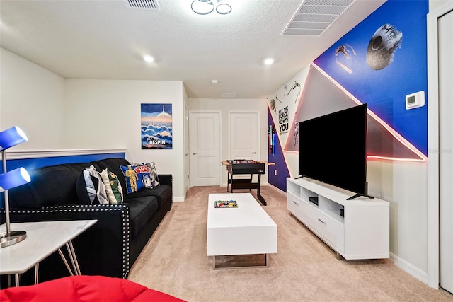 carpeted living room with a textured ceiling