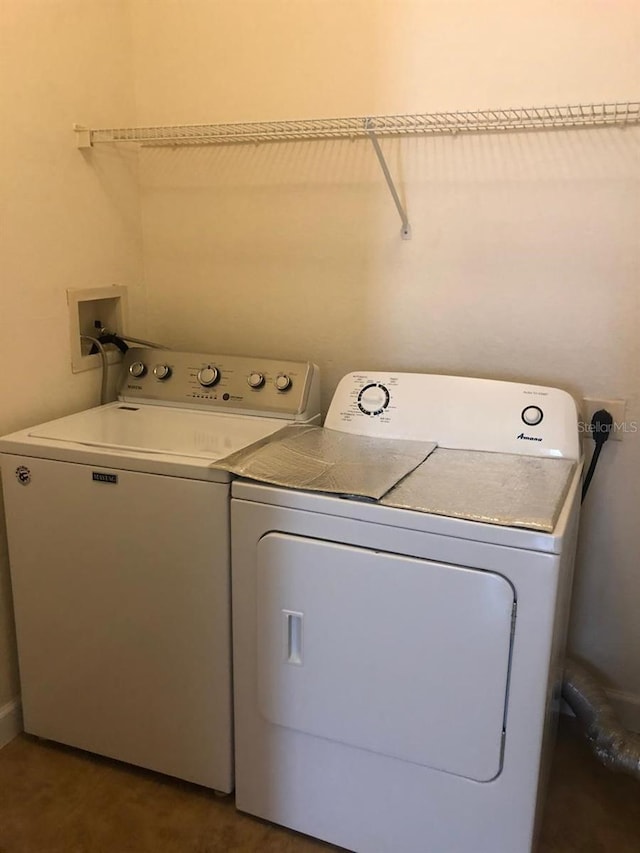 laundry room featuring washing machine and clothes dryer