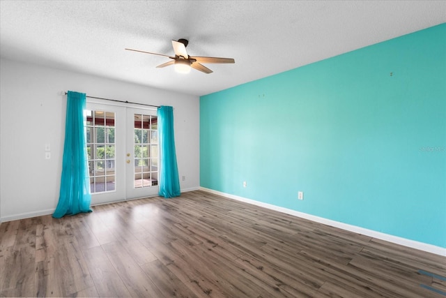 spare room with french doors, ceiling fan, a textured ceiling, wood finished floors, and baseboards