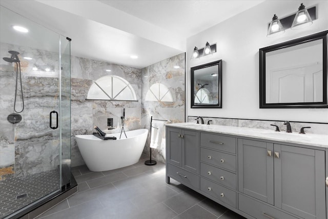 bathroom featuring separate shower and tub, tile patterned flooring, vanity, and tile walls