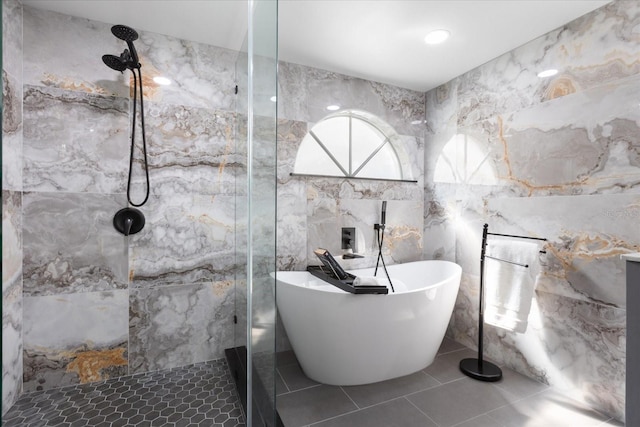 full bathroom featuring tile patterned flooring, tiled shower, a freestanding bath, and tile walls