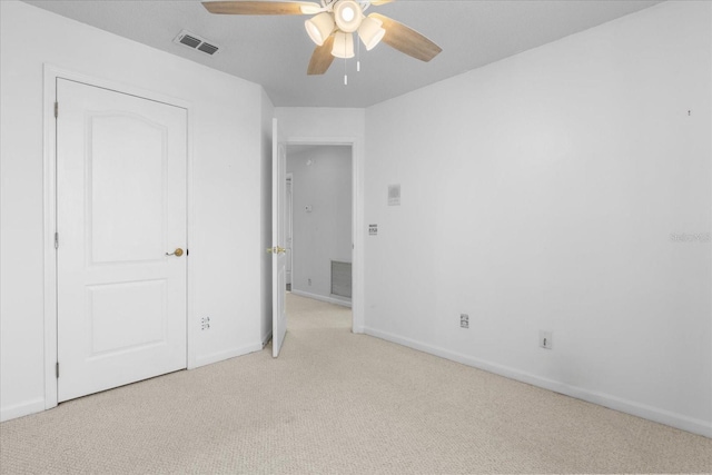 unfurnished bedroom with ceiling fan and light carpet