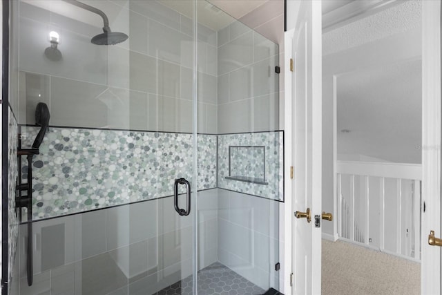 bathroom featuring a shower with shower door