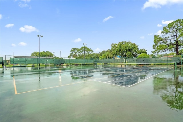 view of tennis court featuring fence