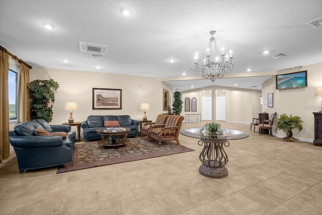 living room with a textured ceiling and a notable chandelier