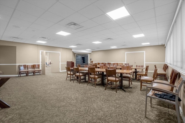 dining room with carpet flooring and a drop ceiling