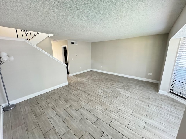 unfurnished living room with a textured ceiling