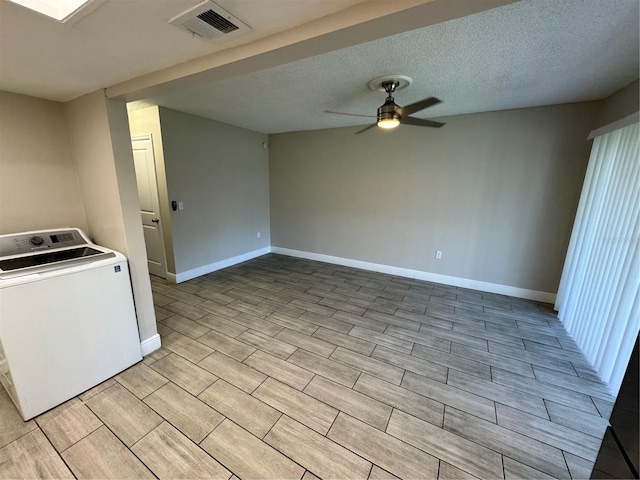 clothes washing area featuring a textured ceiling, washer / clothes dryer, and ceiling fan