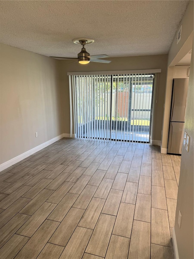 spare room with ceiling fan and a textured ceiling