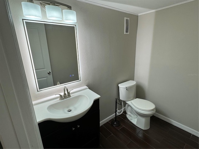 bathroom featuring vanity, toilet, and crown molding