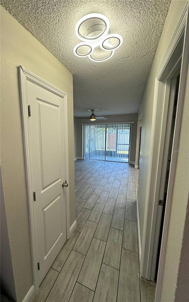 hallway with a textured ceiling