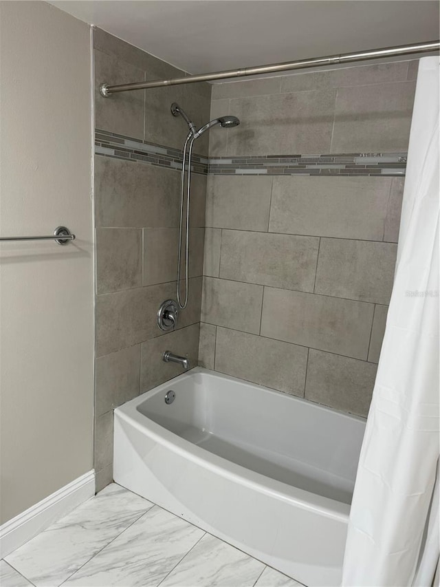 bathroom with shower / bath combo with shower curtain